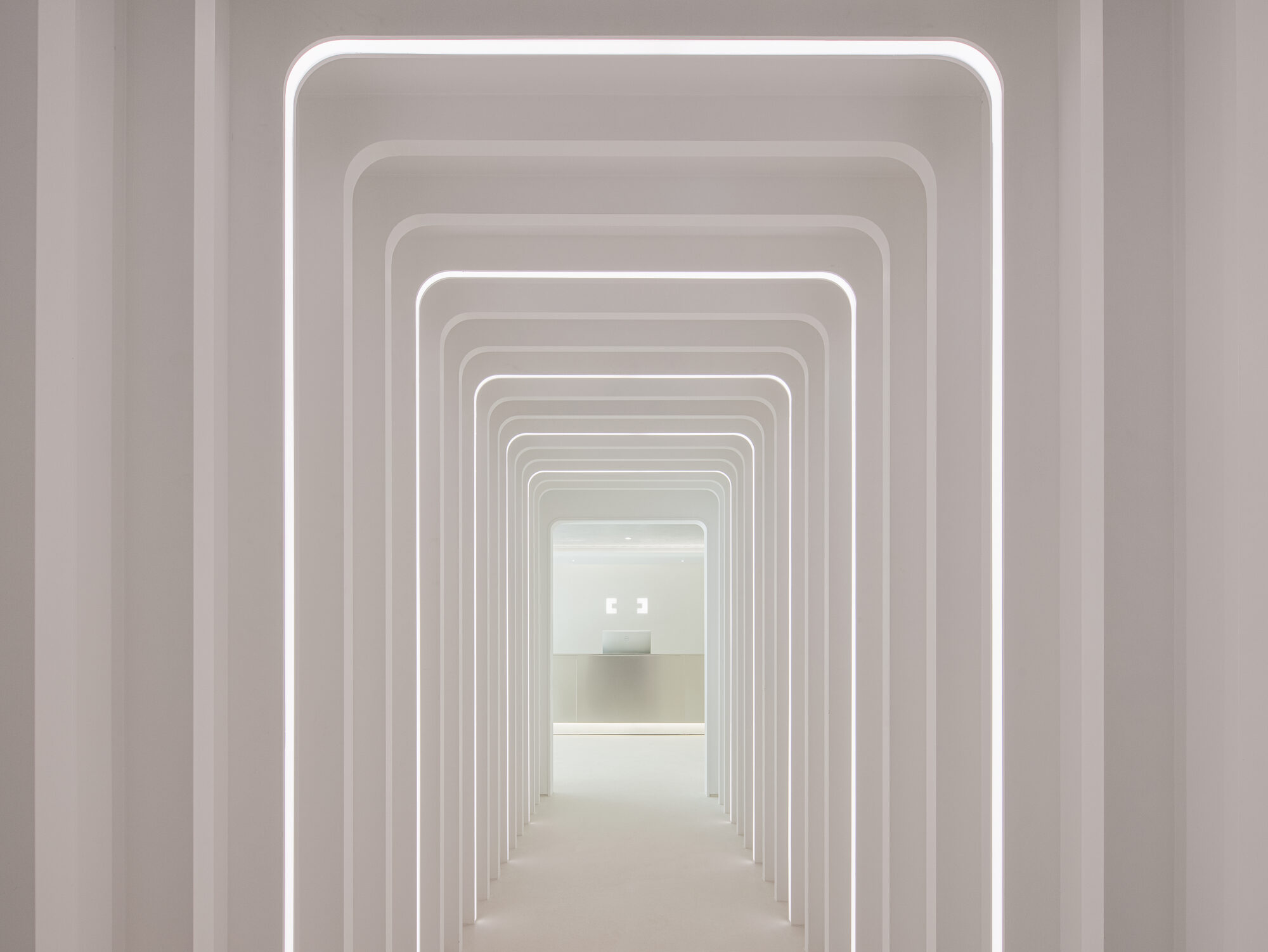 Architectural arched corridor at AMRED Anti-aging Center in Gangnam, Seoul — a series of illuminated white parametric arches leading to a reception area.